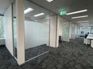 Frosted window film installed on office glass partitions to improve privacy while maintaining natural light in an open-plan workspace.