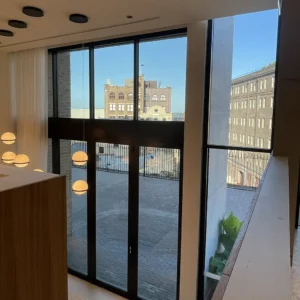 Residential window tinting on large floor-to-ceiling windows in a modern Sydney home