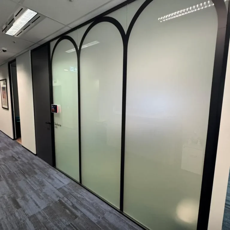 Decorative frosted window film applied to office glass walls, creating privacy while maintaining natural light and a clean, modern architectural finish.