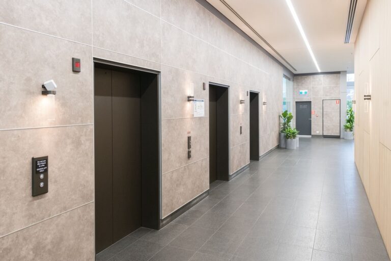 Architectural surface wraps applied to commercial elevator surrounds and interior walls in a Sydney office building