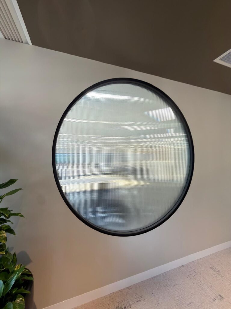 Decorative textured privacy film installed on commercial office glass feature