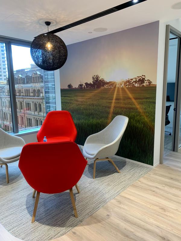 Office feature wall graphic with landscape artwork in a modern meeting area