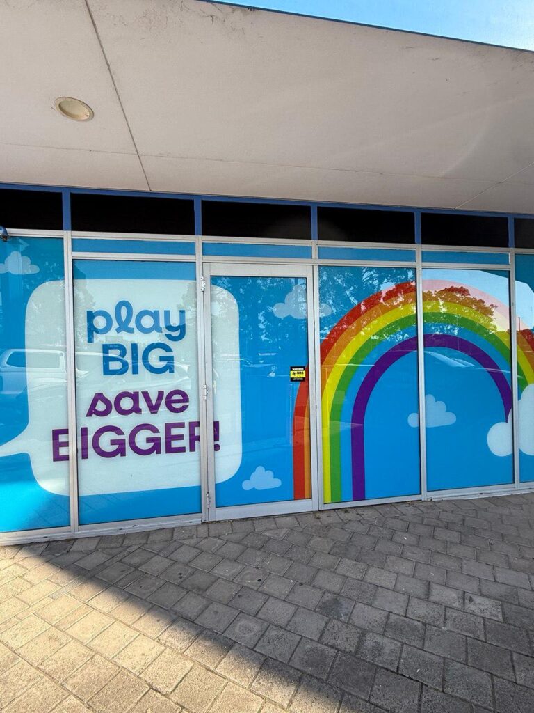 Custom retail window graphics and branded glass signage installed on a commercial shopfront in Sydney