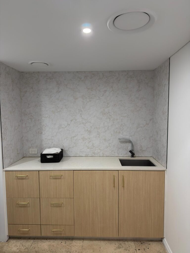 After architectural wrap installation on cabinetry and mirror wall