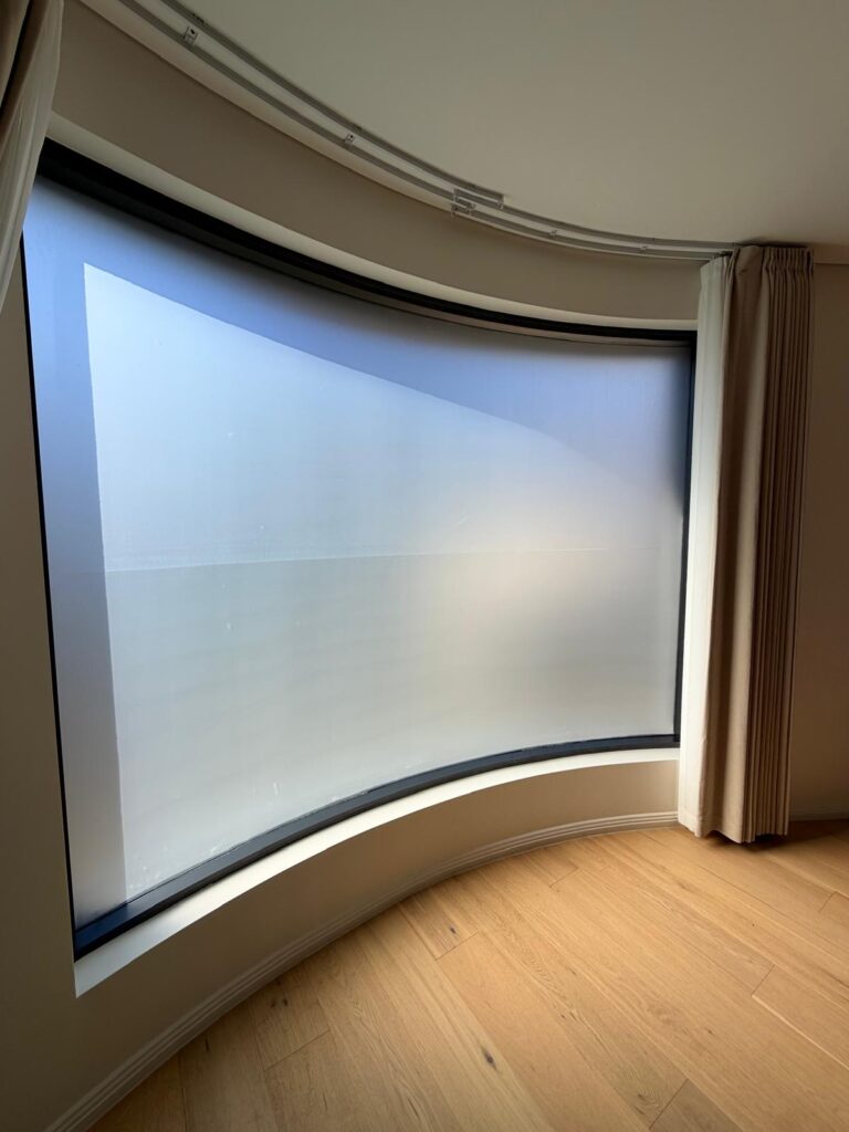 Residential curved window with frosted film installed