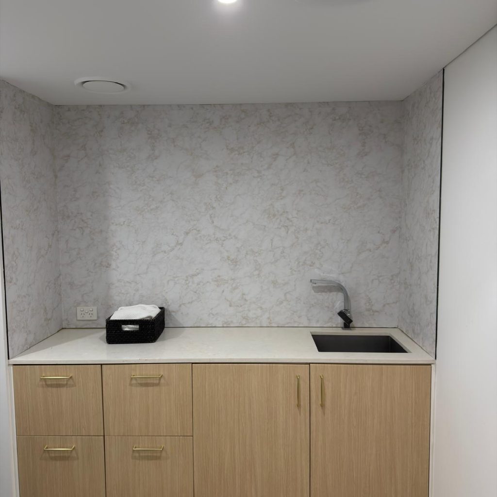 After architectural wrap installation on cabinetry and mirror wall